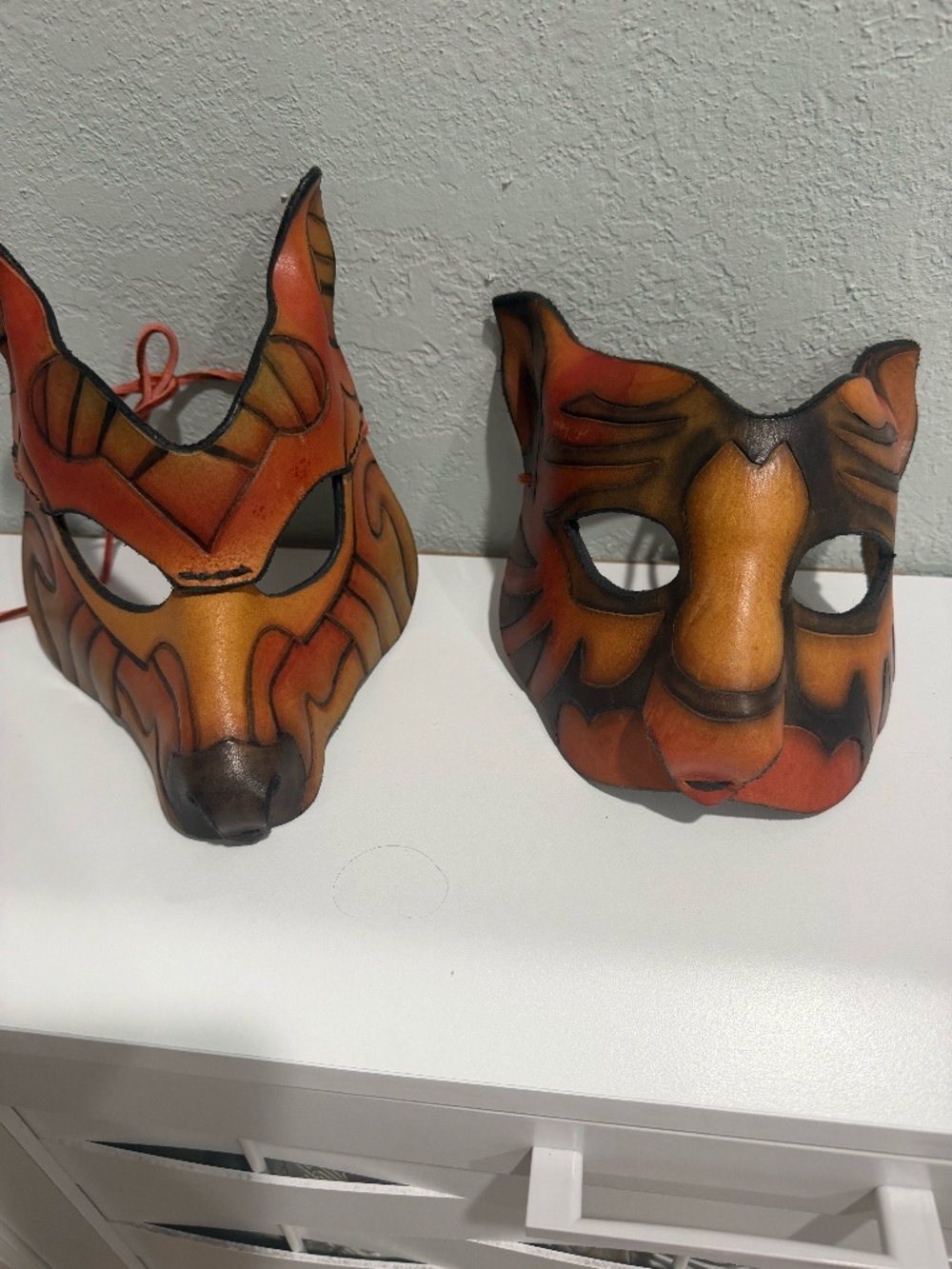 Pair of hand-painted leather animal masks